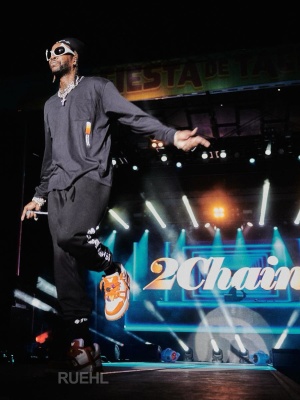 2 Chainz Wearing A Chrome Hearts Beanie Long Sleeve Black Tee And Sweatpants With Lv Trainer Sneakers And Balenciaga Sunglasses