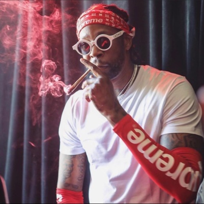 2 Chainz Wearing A Supreme X Louis Vuitton Red Bandana Shooting Sleeve And Sunglasses