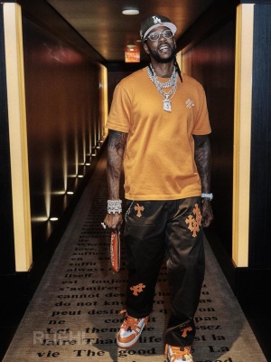 2 Chainz Wearing Chrome Hearts Brown Cross Pants With An Orange Lv Tshirt And Sneakers