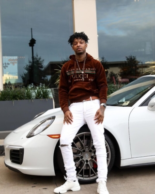 21 Savage Leans On His Porsche 911 In A Gucci Hoodie Amiri Jeans And Lv Belt