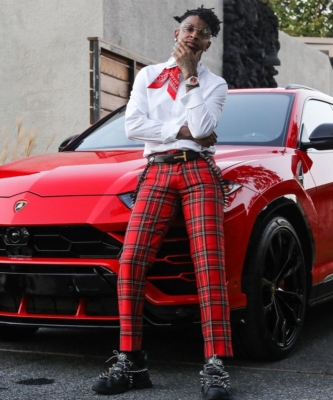 21 Savage Leans On His Urus In A Gucci Burberry And Tom Ford Fit