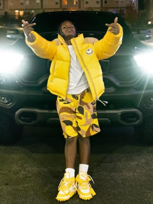 42 Dugg Wearing A Moncler X Palm Angels Puffer With Marni Yellow Camo Shorts And Off White Yellow Sneakers