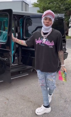 6ix9ine Wearing A Gallery Dept Tee With Amiri Jeans And Crocs
