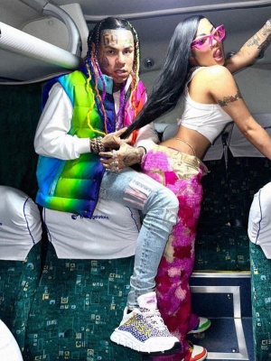 6ix9ine Wearing An Agr Neon Puffer Jacket With Amiri Jeans And Versace Sneakers