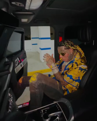 6ix9ine Wearing Gold Versace Sunglasses And A Blue Silk Shirt With Amiri Mx1 Jeans