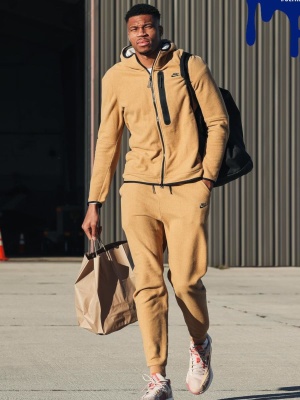 Giannis Ugo Antetokounmpo Wearing A Nike Elemental Gold Fleece Hoodie And Joggers With Nike Sneakers