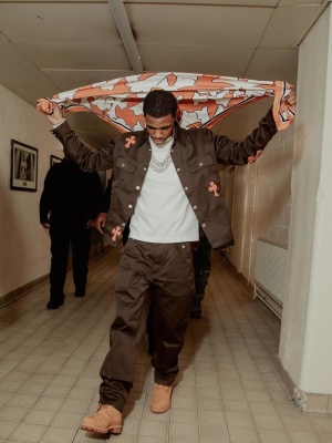A Boogie Wearing A Chrome Hearts Cross Workwear Shirt And Pants With Timerland Boots And An Orange Scarf