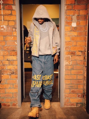A Boogie Wearing A Kapital Kountry Grey Scarf Logo Hoodie With Blue And Yellow Print Jeans And Timberland Boots