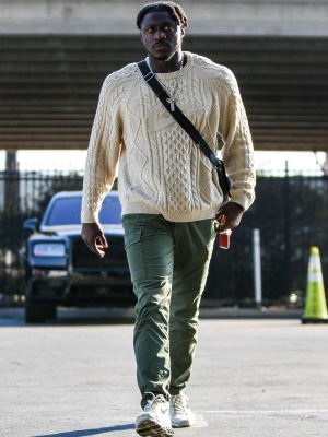Aj Brown Wearing A Nike Life Sweater With Olive Green Cargo Pants And Nike Ivory Caged Sneakers