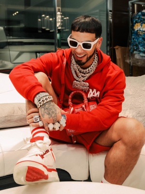 Anuel Aa Wearing Amiri Red Ma Logo Hoodie And Shorts With A Red Banana Bag And Ma1 Sneakers