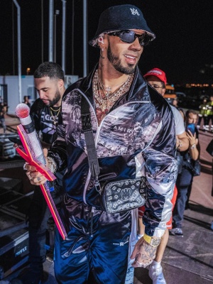 Anuel AA Wearing a Louis Vuitton Jazz Tee With Match 'Trainer' Sneakers