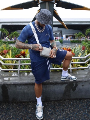 Anuel Aa Wearing An Amiri Bucket Hat With Blue Logo Tee And Shorts With Denim Sneakers