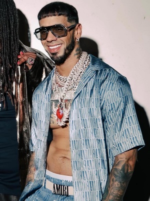 Anuel Aa Wearing Dita Blue Sunglasses With An Amiri Gradient Silk Shirt And Shorts With An Ap Watch