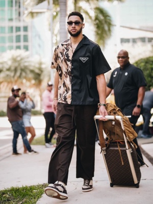 Ben Simmons Wearing A Prada Double Math Shirt With Brown Pants Dior B27 Sneakers A Brown Backpack And Louis Vuitton Luggage