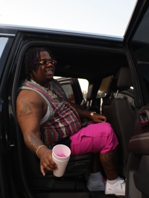 Big Homiie G Wearing A Supreme X Coogi Tank Top With Pink Shorts And Supreme Af1s