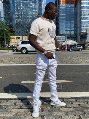 Bobby Shmurda Wearing A Dior X Kenny Scharf Sweater With White Jeans And Dior B27 Sneakers