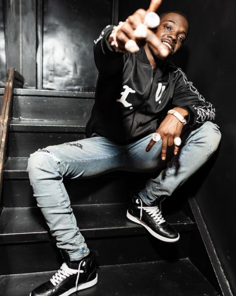 Bobby Shmurda Pairs a Louis Vuitton Track Jacket & Sneakers With Amiri Jeans