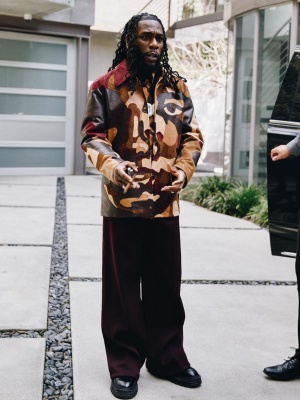 Burna Boy Wearing A Louis Vuitton Patchwork Faces Jacket With Black Baroque Boots