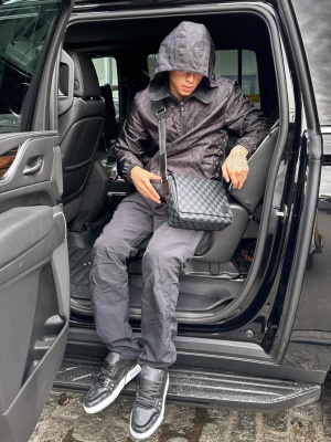 Central Cee Wearing A Louis Vuitton Black Monogram Windbreaker Damier Messenger Bag And Black Lv Trainer Sneakers