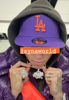 Central Cee Wearing A New Era Dodgers Purple Hat With An Off White Orange Bag And Moncler Purple Maya 70 Jacket