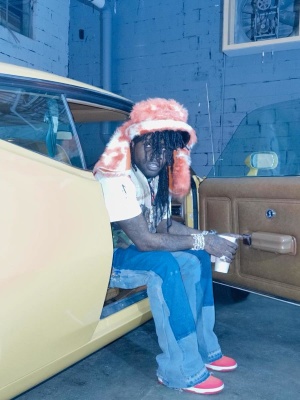 Chief Keef Wearing A Marni Shlearing Hat With A Gallery Dept Vest And Blue Flared Jeans