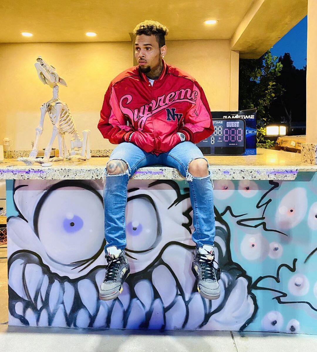 Chris Brown Wearing a Supreme Bomber with Off-White x Jordan 5s