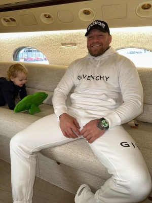 Conor Mcgregor Wearing A Givenchy Black Logo Hat White Logo Hoodie White Sweatpants And White Sneakers