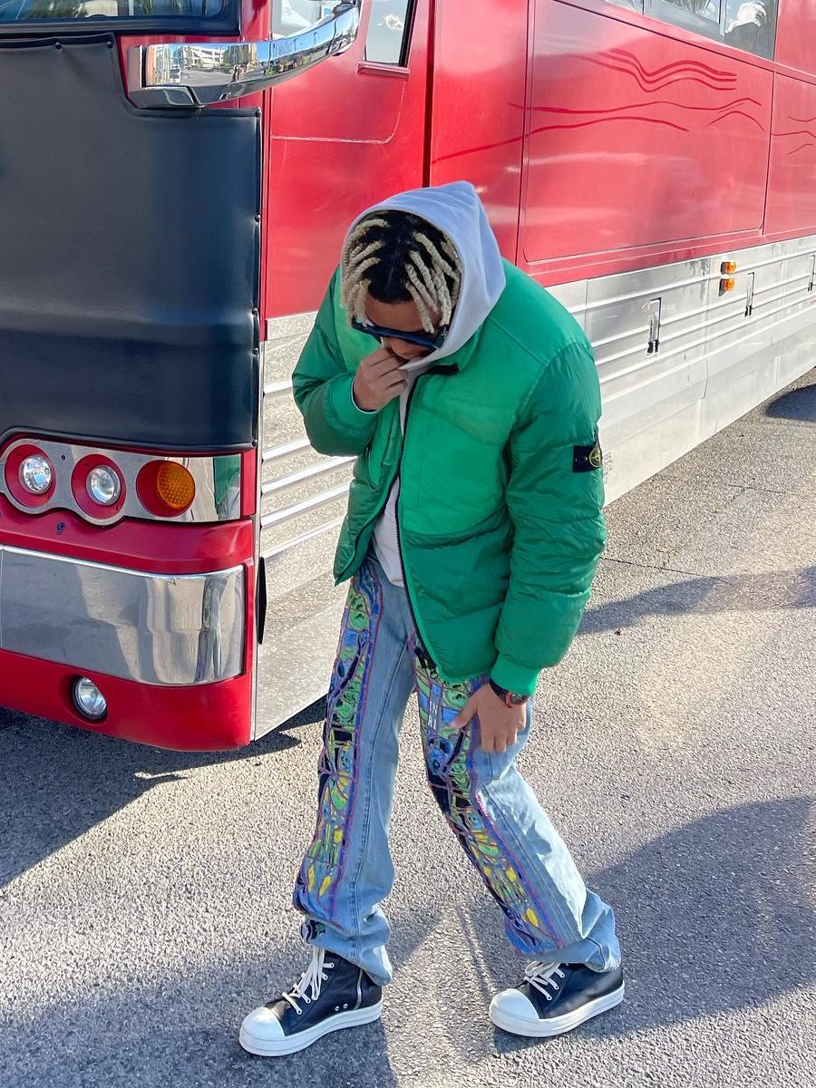 Cordae Wearing Louis Vuitton Sunglasses With a Stone Island Puffer & Stained Glass Jeans