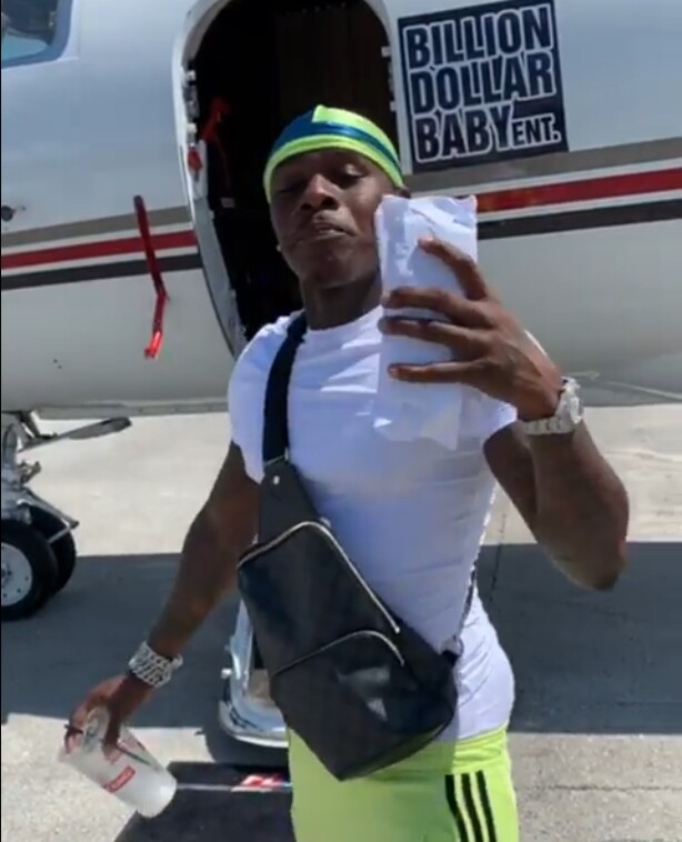 DaBaby Boarding a Jet in Adidas Joggers & Louis Vuitton Bag