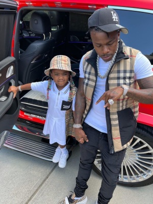 Dababy Wearing A 47 Brand Dodgers Hat With A Burberry Puffer Vest Amiri Velour Jeans And Burberry Regis Sneakers