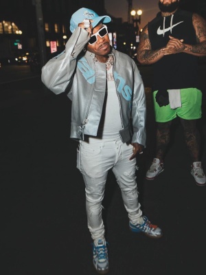Dababy Wearing A Light Blue Trucker Hat With A Vanson Silver And Light Blue Leather Jacket Amiri Mx1 Jeans And Nike X Off White Rubber Dunk Sneakers