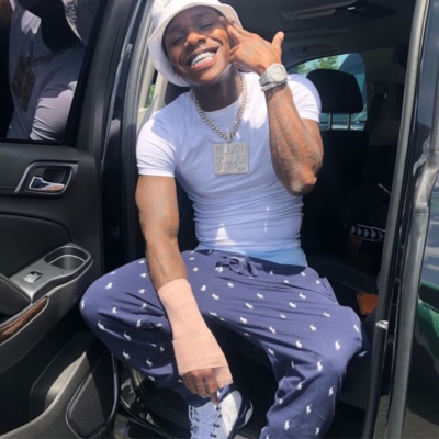 Dababy Wearing A White Adidas Bucket Hat Navy Polo Pants And White And Black Jordans