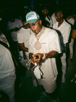 Dabay Wearing A Bape White And Light Blue Allover Trucker Hat With A White Balenciaga Tee And Sweatshorts