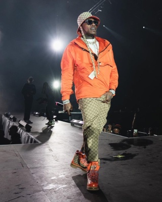 Daby Wearing A Gucci X The North Face Bucket Hat Orange Anorak Jacket Beige Gg Canvas Pants And Boots