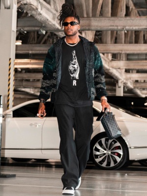 Davante Adams Wearing Prada Sunglasses Dior Fleece Jacket Issey Miyaka Pleated Pants And A Louis Vuitton Bag