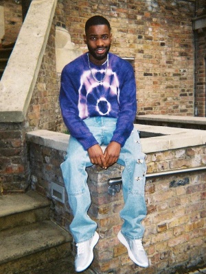 Dave Wearing An Off White Purple Tiedye Sweater And Bee Jeans And Prada Sneakers