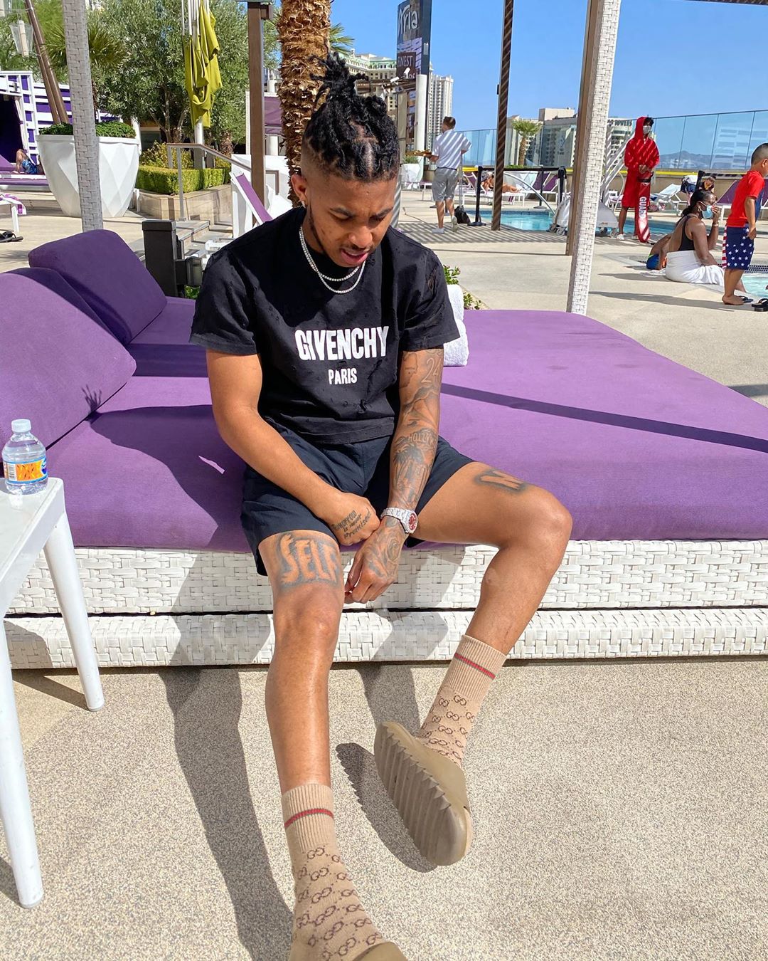 DDG Chills In a Givenchy Tee, Gucci, & Yeezy Slides Poolside In Vegas |  Incorporated Style