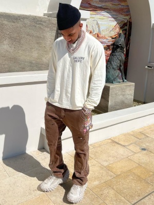 Ddg Wearing A Gallery Dept Ivory Logn Sleeve Tee With Gallery Dept Brown Painted Carpenter Pants And Balenciaga White Defender Sneakers