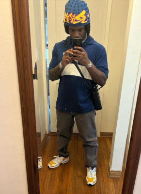 Denzel Curry Wearing A Blue Flames Beanie With A Carhartt Wip Polo And Nike Sneakers