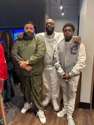 Dj Khaled Watches Superbowl Lvii In A Prada Olive Green Anorak And Trackpants With Jordan 3s
