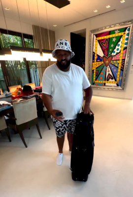 Dj Khaled Wearing A Chanel Bucket Hat Polo Tee And Socks And Jordan Shorts
