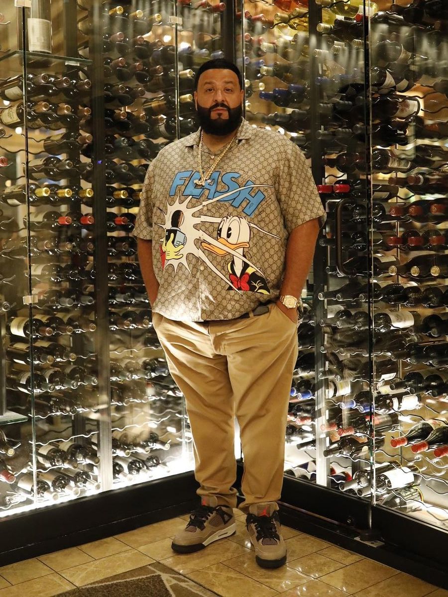 DJ Khaled Wearing a Beige Gucci x Disney, Rolex, & Jordan Outfit