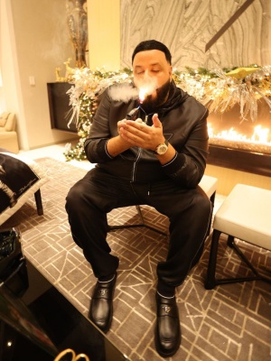 Dj Khaled Wearing A Prada Black Contrast Stitch Silk Jacket And Pants With A Rolex Watch And Prada Black Leather Shoes