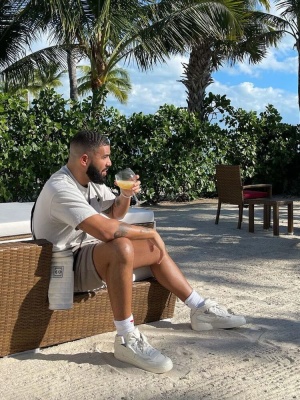 Drake Wearing A Chrome Hearts Tee With A Chanel Bag And Nike X Comme Des Garcons Sneakers