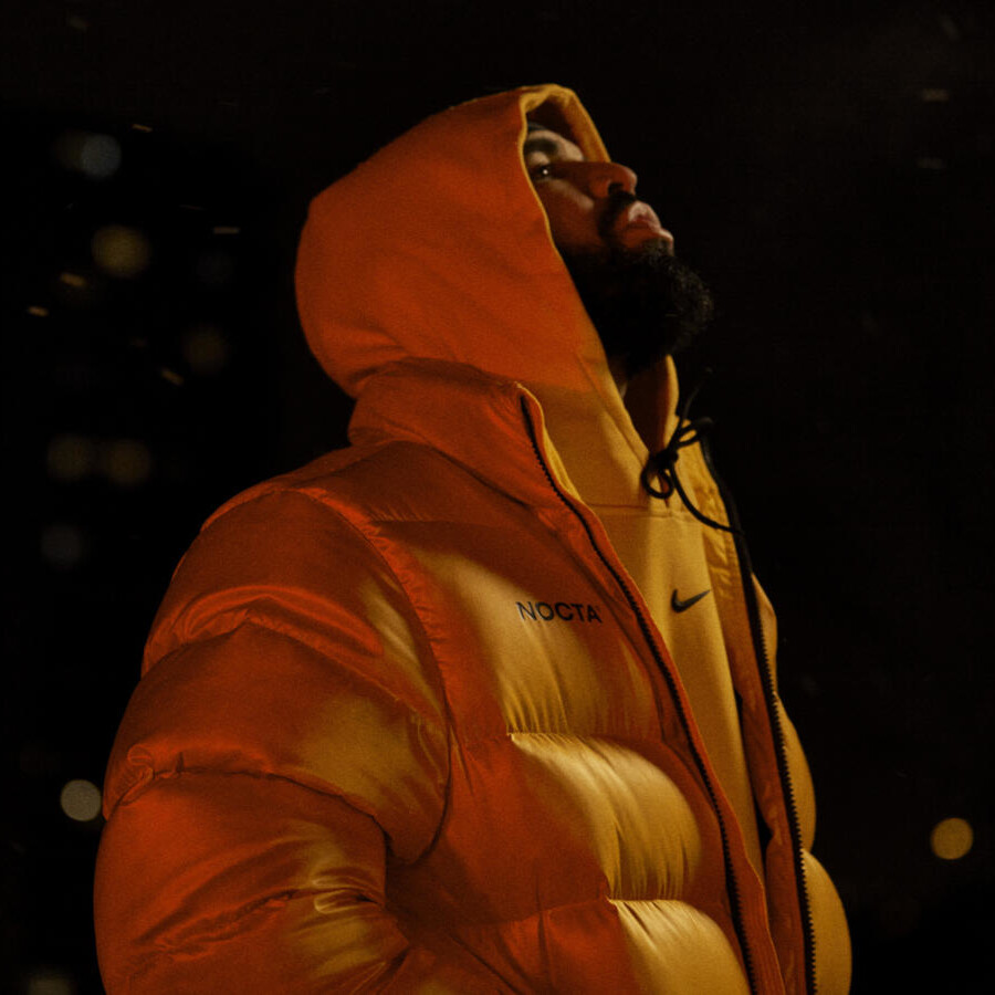Drake Wearing a Nike x NOCTA Gold Puffer Jacket & Hoodie