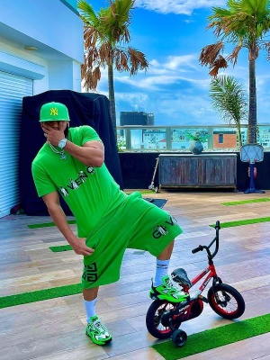 El Alfa Wearing A Green Yankees Hat With A Givenchy Grim Reaper Tee And And Shorts With Louis Vuitton Sneakers