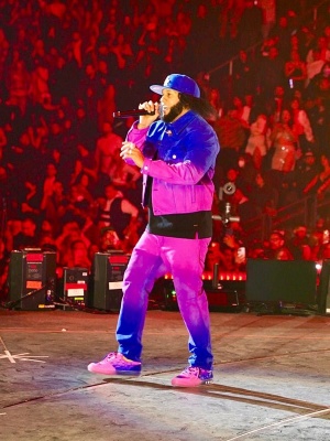 El Alfa Wearing A Louis Vuitton Blue And Neon Pink Gradient Denim Jacket And Jeans With Neon Pink And Blue Low Top Sneakers