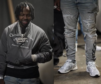 Est Gee Wearing A Dior Grey Atelier Bomber Jacket With Amiri Black Flame Bandana Jeans And Dior Sneakers