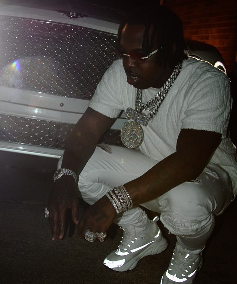EST Gee Wearing an All White Dior Tee & Sneakers With Amiri Jeans Outfit