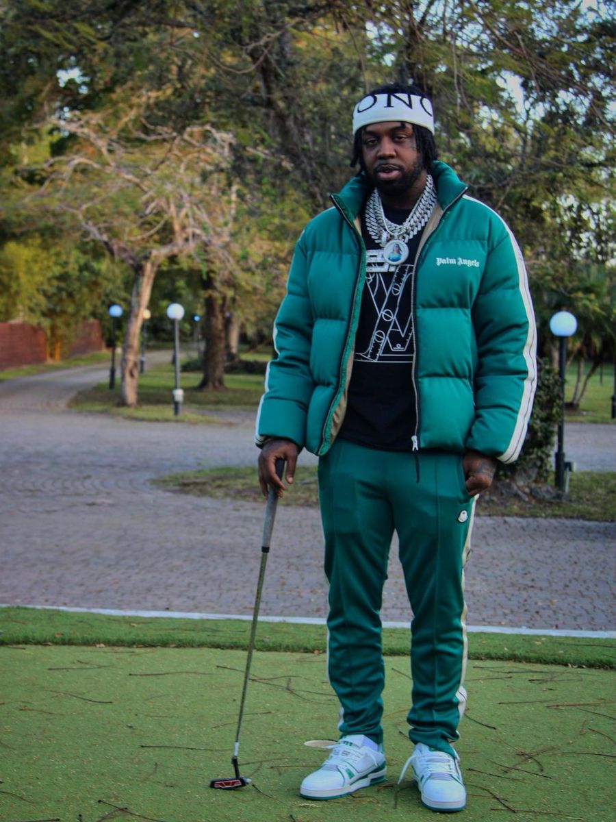 EST Gee Wearing a Moncler x Palm Angels Puffer & Trackpants With Louis Vuitton Sneakers